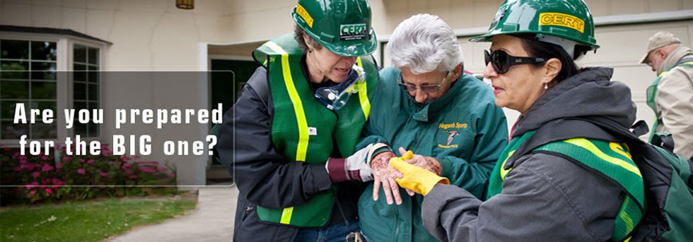 Lamorinda CERT volunteers in helmets and vests practicing hands-on medical care during a training exercise.